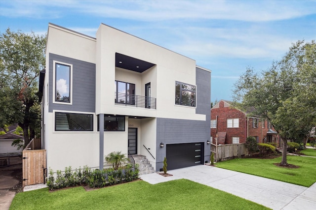 contemporary house featuring a front yard and a garage