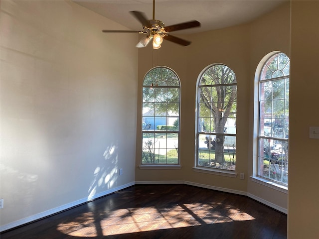 empty room with ceiling fan and a wealth of natural light