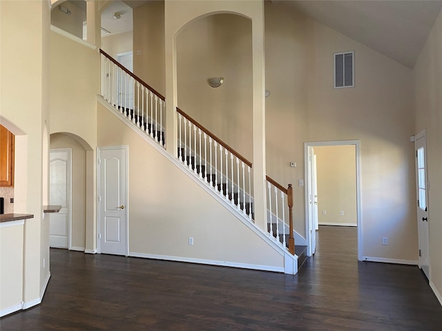 interior space with hardwood / wood-style flooring and high vaulted ceiling