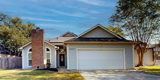 view of front of home featuring a front lawn and a garage