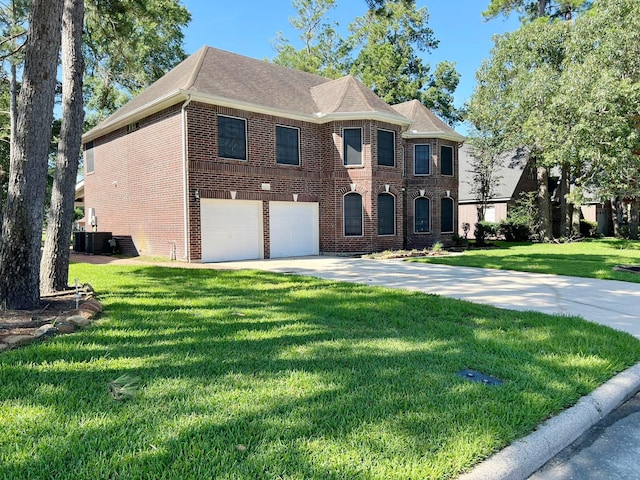 view of front of home featuring a garage, a front lawn, and cooling unit