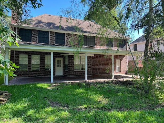 back of house with a lawn