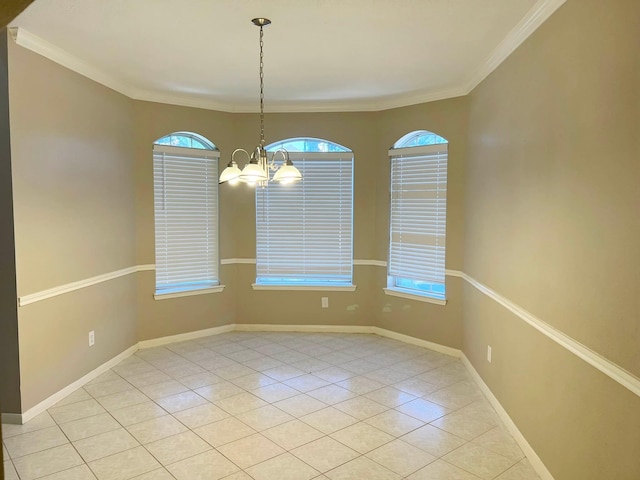 tiled spare room with an inviting chandelier and ornamental molding