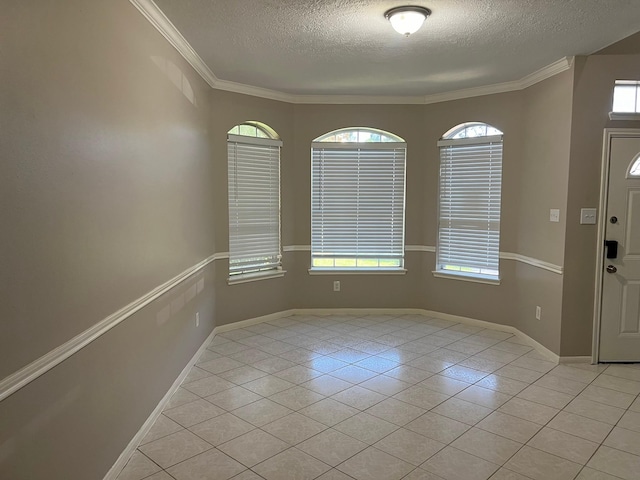 foyer entrance featuring light tile patterned floors, a textured ceiling, and ornamental molding