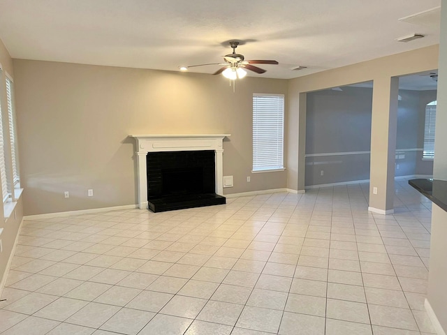 unfurnished living room featuring light tile patterned floors and ceiling fan