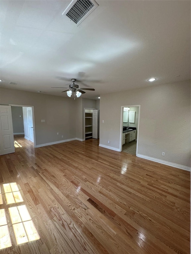 unfurnished living room with ceiling fan and light wood-type flooring