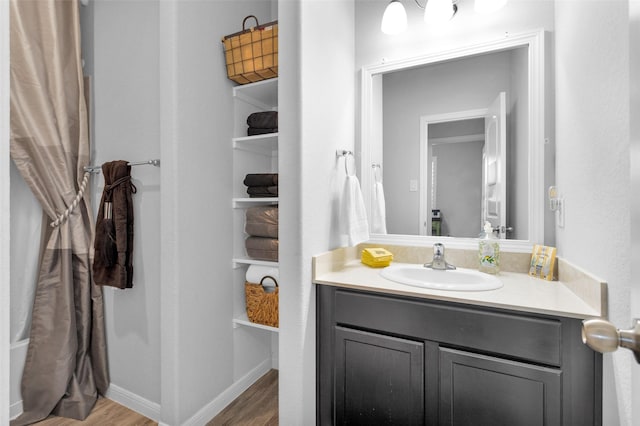 bathroom with vanity and hardwood / wood-style flooring