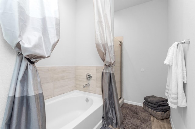 bathroom featuring shower with separate bathtub