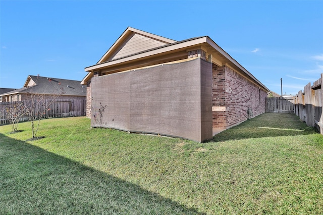 view of side of home featuring a lawn