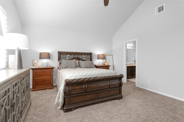 carpeted bedroom featuring ensuite bath, ceiling fan, and vaulted ceiling