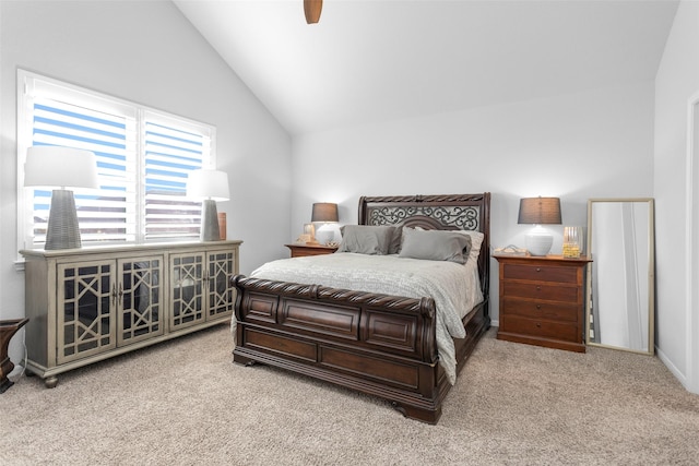 carpeted bedroom with ceiling fan and vaulted ceiling