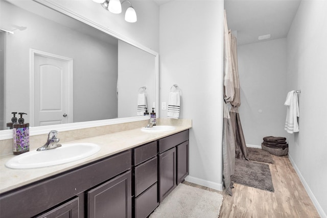 bathroom with vanity and hardwood / wood-style flooring