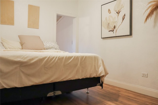 bedroom with hardwood / wood-style flooring