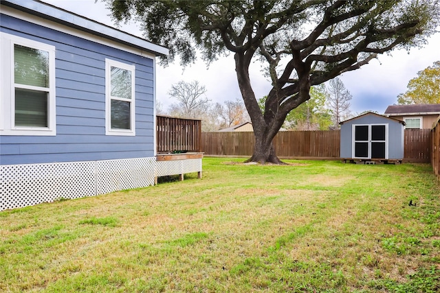 view of yard with a shed and a wooden deck