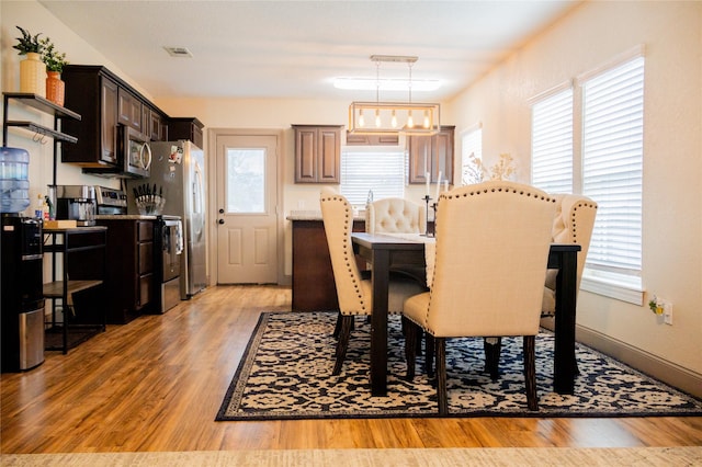 dining area with light hardwood / wood-style flooring