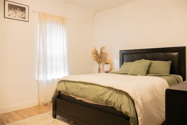 bedroom featuring wood-type flooring and multiple windows