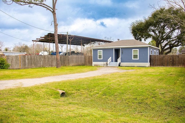 back of property featuring a carport and a yard