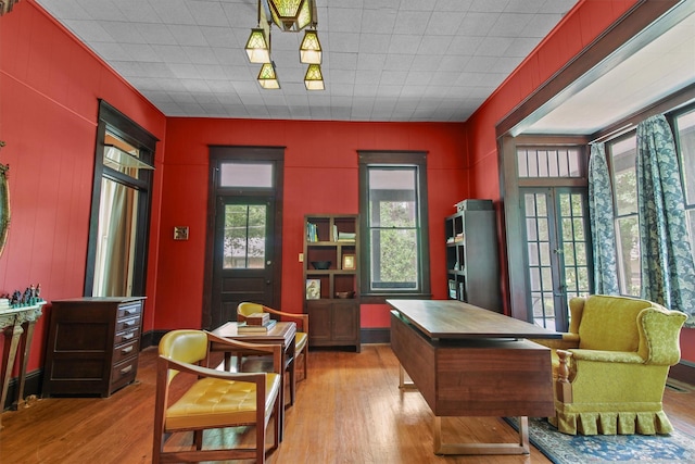 living area featuring french doors and light hardwood / wood-style flooring