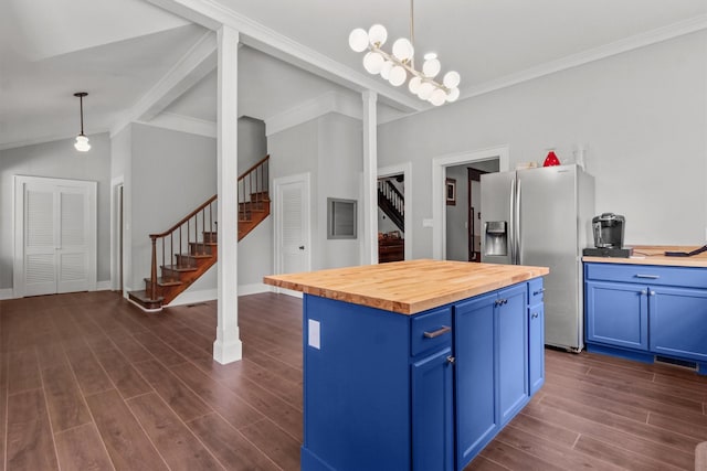 kitchen with butcher block countertops, decorative light fixtures, a center island, and stainless steel refrigerator with ice dispenser