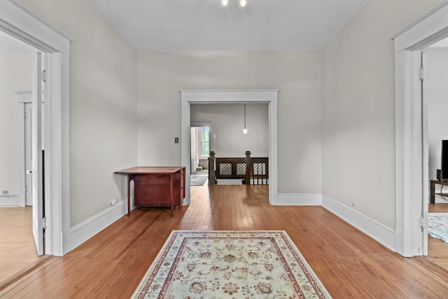 hall with hardwood / wood-style flooring