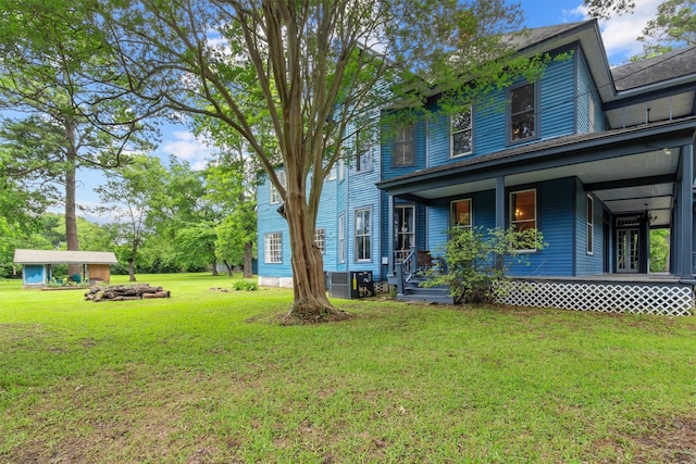 view of yard with a porch and cooling unit