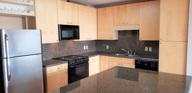 kitchen featuring dark stone countertops, sink, black appliances, and light brown cabinets