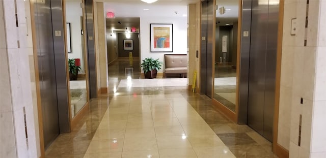 corridor with light tile patterned floors and elevator