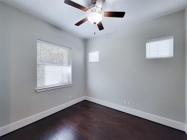 spare room with ceiling fan and dark wood-type flooring