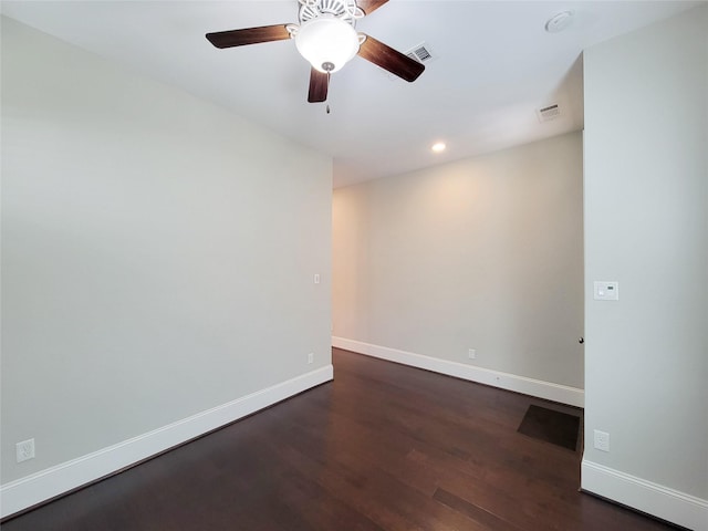 spare room with ceiling fan and dark wood-type flooring