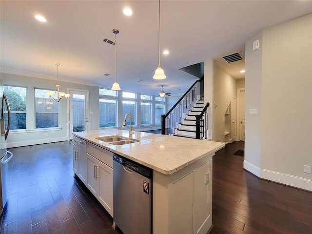 kitchen with white cabinetry, sink, stainless steel dishwasher, an island with sink, and decorative light fixtures