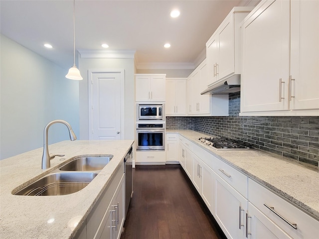 kitchen with stainless steel appliances, white cabinetry, hanging light fixtures, and sink