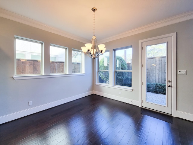 unfurnished dining area with a notable chandelier, dark hardwood / wood-style flooring, and ornamental molding