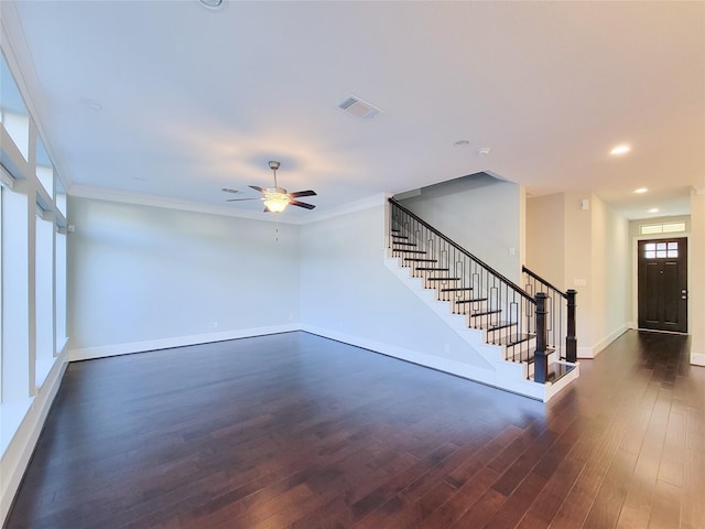 unfurnished living room featuring dark hardwood / wood-style floors, ceiling fan, and crown molding