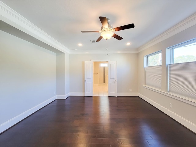 empty room with dark hardwood / wood-style floors, ceiling fan, and ornamental molding