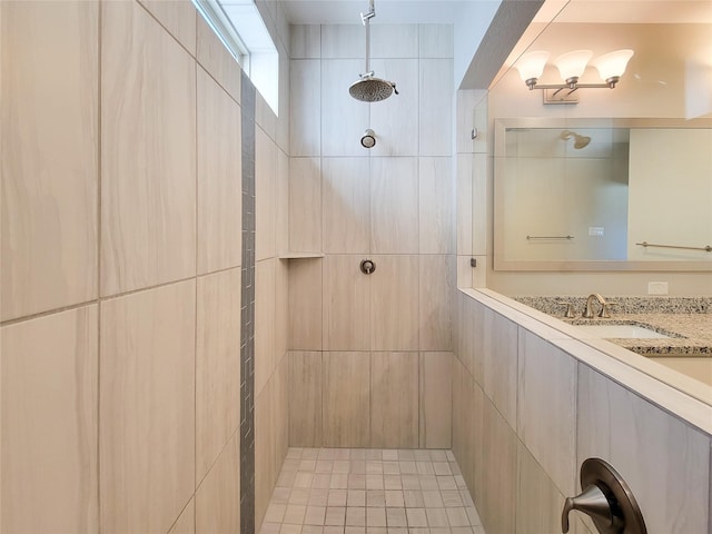 bathroom with a tile shower and sink