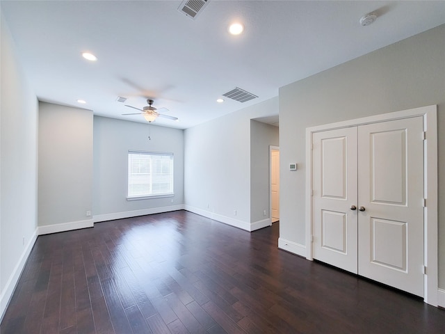 spare room featuring dark hardwood / wood-style floors and ceiling fan