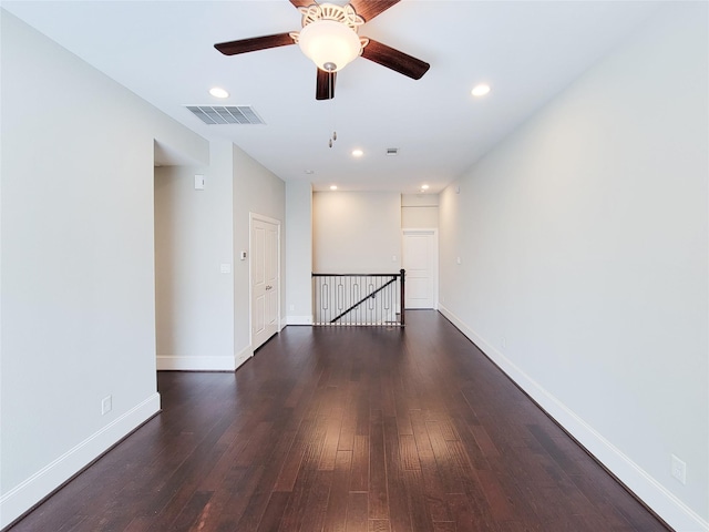 spare room with ceiling fan and dark wood-type flooring