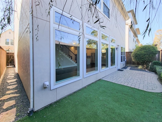 view of home's exterior featuring a yard and a patio