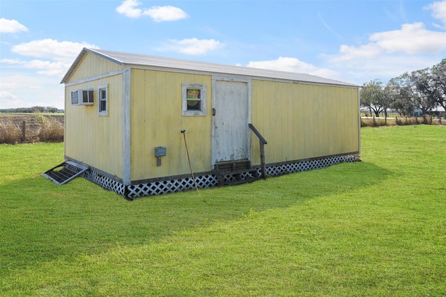 view of outdoor structure featuring a lawn