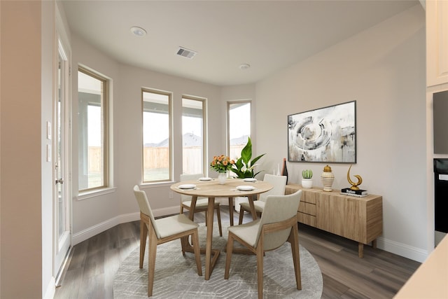 dining space with dark wood-type flooring