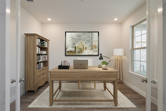 office area with a healthy amount of sunlight, dark wood-type flooring, and french doors