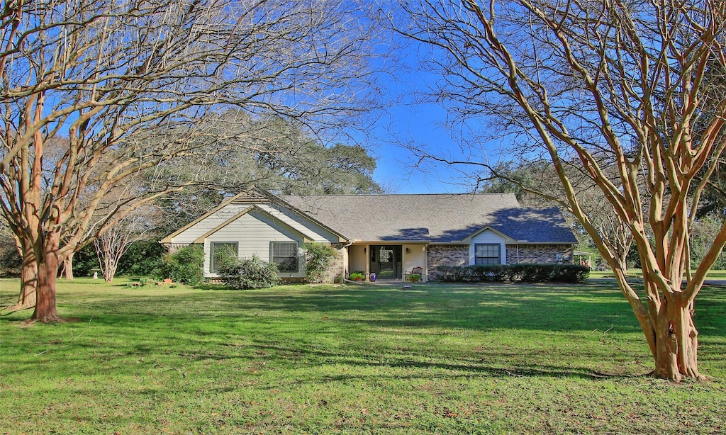 ranch-style house with a front lawn