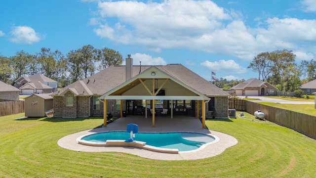 view of pool featuring a lawn, a gazebo, a patio area, and a shed