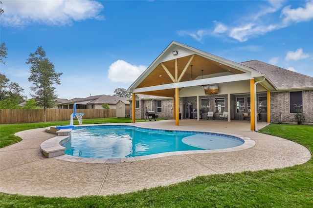 view of pool with ceiling fan, a yard, and a patio