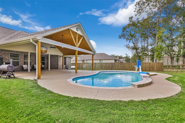 view of pool featuring a lawn, ceiling fan, and a patio area