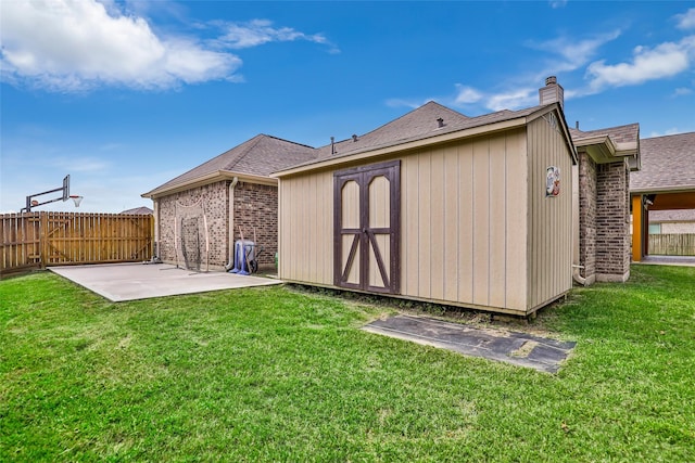 back of house with a yard and a patio