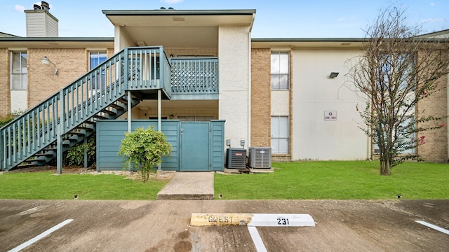 back of property featuring a yard and cooling unit