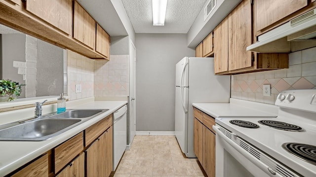 kitchen with white appliances, sink, decorative backsplash, a textured ceiling, and light tile patterned flooring