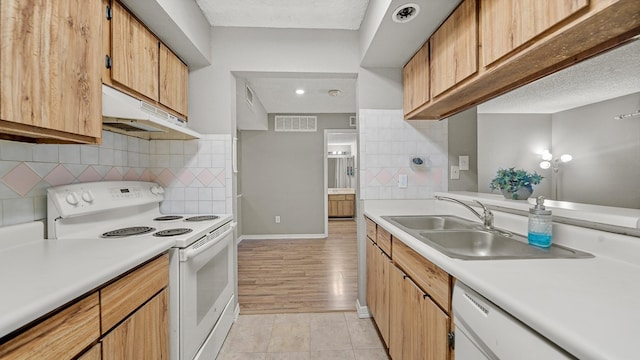 kitchen with white appliances, sink, decorative backsplash, a textured ceiling, and light tile patterned flooring