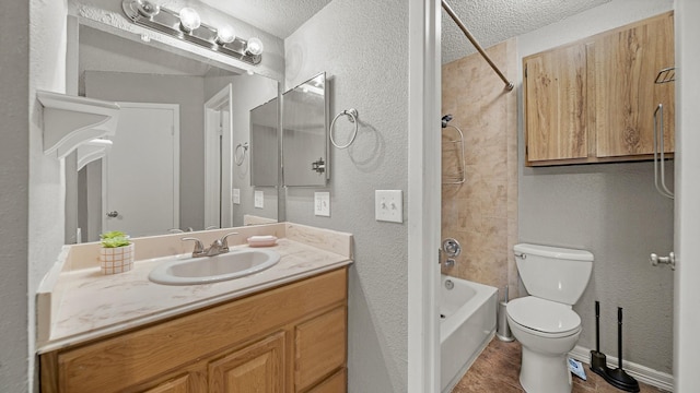 full bathroom featuring vanity, toilet, washtub / shower combination, and a textured ceiling